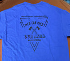 A bright blue short-sleeve t-shirt laid flat on a brown surface, showing the back with a black graphic print that reads 'Metachromatic Leukodystrophy', 'MILD CAN KISS', 'OUR AXES', and '#AXELSTRONG' with crossed axes. Two small white sticky notes on the lower back read 'LARGE' and 'SHORT SLEEVE'.