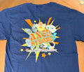 A blue short-sleeve t-shirt laid flat on a tan surface, showing a large colorful back graphic with the words 'AXEL STRONG' and smaller text 'METACHROMATIC LEUKODYSTROPHY.' 