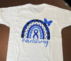 A white short-sleeve T-shirt laid flat on a dark brown surface, featuring a blue awareness ribbon and rainbow graphic on the front with the text '#axelstrong' and a blue butterfly. 